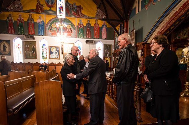 Effie is comforted by family and friends at her husband Apostolos’ funeral service at St Eleftherios Church in Brunswick.