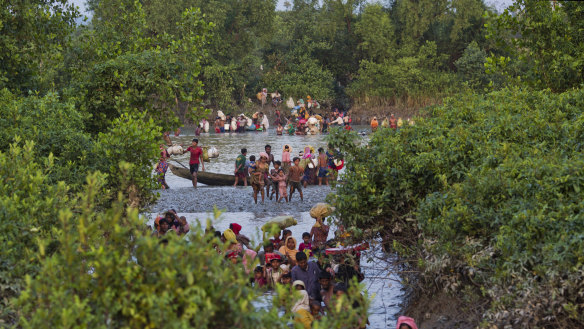 Groups of Rohingya Muslims cross the Naf River at the border between Myanmar and Bangladesh, near Palong Khali, Bangladesh in 2017.