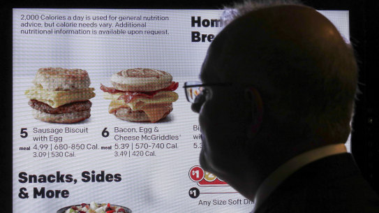 Scott Morrison admires the breakfast options on a 'smart' McDonald's drive-through menu during his visit to Chicago. 