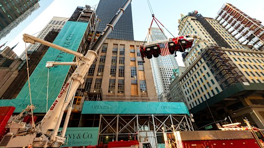 A crane hoisted another crane onto the roof of a building as part the transformation of Tiffany & Co’s Fifth Avenue flagship store.