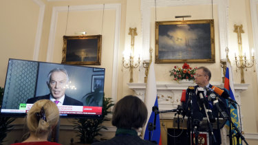 Russian Ambassador Alexander Yakovenko looks towards a screen showing former British Prime Minister Tony Blair, as he speaks during a press conference about current news events, at his residence in London on Friday.