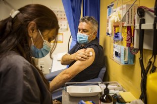 Michael Graham, chief executive of the Victorian Aboriginal Health Service, receives his AstraZeneca vaccination in March. 