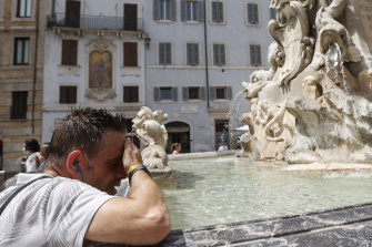 A man refreshes himself at a fountain in Rome during last year’s heatwave.