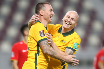 Mitch Duke and Aaron Mooy celebrate the former’s 70th-minute strike against China.