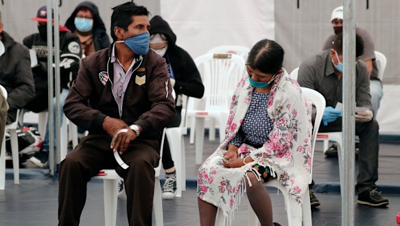 Patients in Quito, Ecuador. wait to be treated for COVID-19 inside a tent set up outside the Instituto de Seguridad Social Sur hospital, which is exclusively treating coronavirus patients.