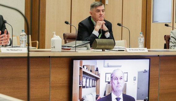 Department of Health secretary Brendan Murphy (seated) and Aged Care Minister Richard Colbeck (appearing via videoconference) at a Senate select committee hearing in Canberra this week.