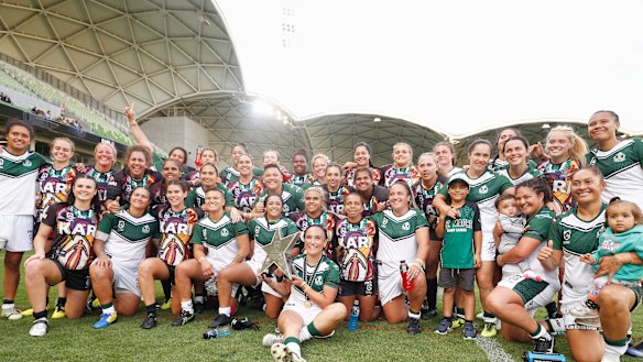 Ground-breaking: Players from both sides pose after the match.