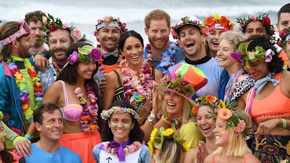 Britain's Prince Harry and Meghan, the Duchess of Sussex, pose at Bondi Beach with surfing community group, known as OneWave, who raise awareness for mental health and wellbeing.