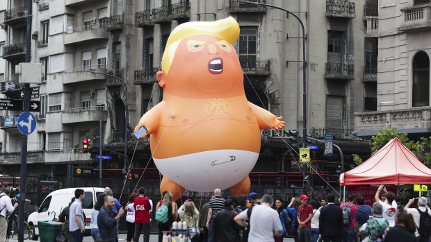 A Donald Trump baby balloon is inflated during a G20 protest in front of the Argentine National Congress building in Buenos Aires. 