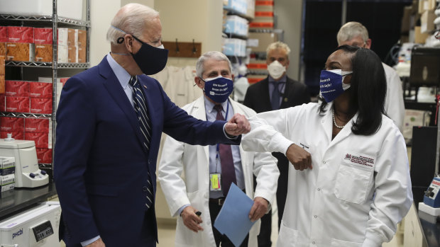 US President Joe Biden wears a protective mask while greeting Kizzmekia Corbett, the immunologist who had a key role in developing a US response to the coronavirus.