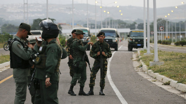 Members of the Venezuelan army and National Guard block the main access to the Tienditas International Bridge that links Colombia and Venezuela on Thursday.