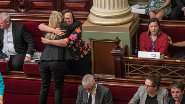 After a marathon 29-hour sitting to pass euthanasia laws in 2017, Fiona Patten stands on the seats to hug Labor’s Harriet Shing.