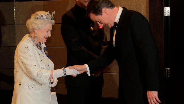 The Queen receives PM David Cameron at a Commonwealth Heads of State banquet in 2011.