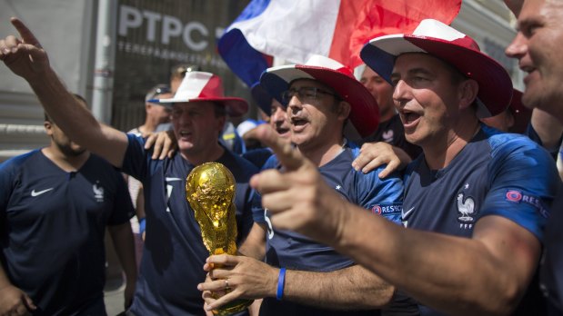 Expectant: French fans with a model World Cup in the streets of Moscow.