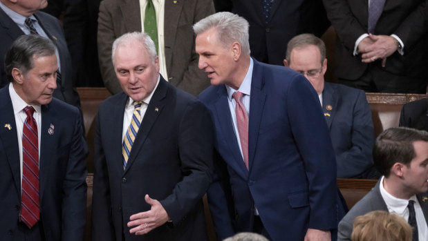 Ex-House Republican Leader Kevin McCarthy confers with Minority Whip Steve Scalise, left, before Ukrainian President Volodymyr Zelensky speaks in December.