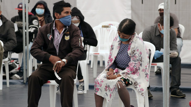 Patients in Quito, Ecuador. wait to be treated for COVID-19 inside a tent set up outside the Instituto de Seguridad Social Sur hospital, which is exclusively treating coronavirus patients.