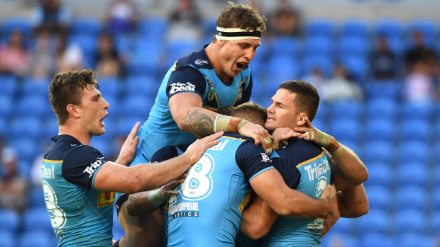Comeback: Gold Coast celebrate on their way to a drought-breaking win over the Knights. 
