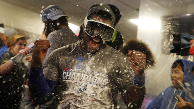 Puig's teammates douse him in champagne as they celebrate their victory.