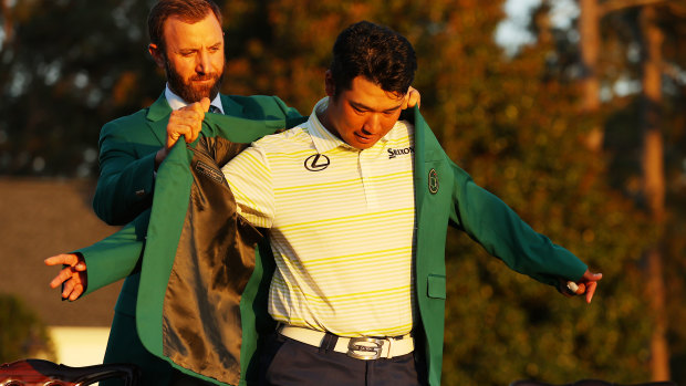 Hideki Matsuyama of Japan is awarded the Green Jacket by 2020 Masters champion Dustin Johnson.