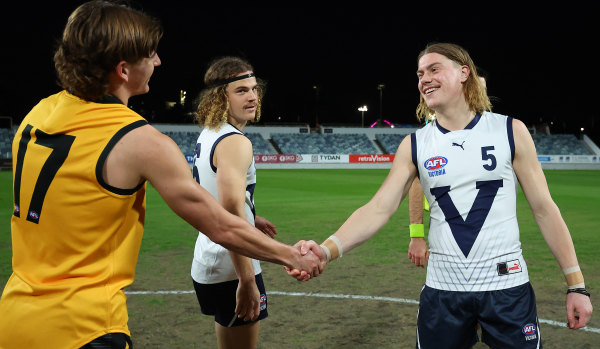 Vic Country’s Harley Reid (right) shakes Daniel Curtin’s WA teammate Riley Hardeman’s hand before their clash in June.