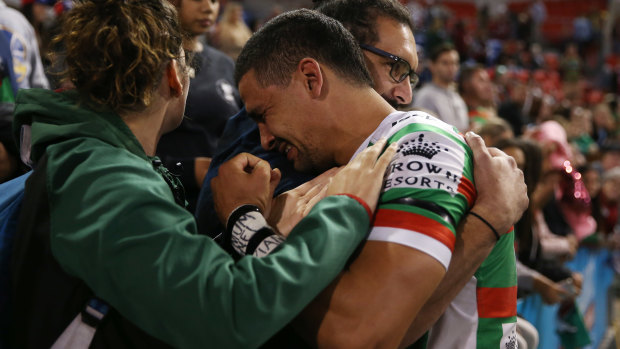 Outpouring of emotion: Walker breaks down in tears as he is embraced by brother Ryan and partner Nellie at full-time.