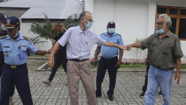 Xanana Gusmao, right, former East Timorese president and prime minister, gives a fist bump to Richard Daschbach, after a court hearing in Oecusse, East Timor, in February.