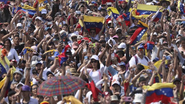 Concert goers unfurl their Venezuelan flags during the Venezuela Aid Live concert on the Colombian side of the Tienditas International Bridge near Cucuta, Colombia.