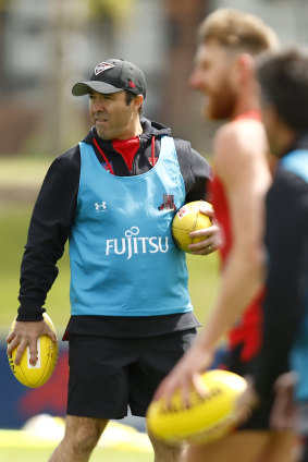 New Essendon coach Brad Scott runs a careful eye over his group at training.