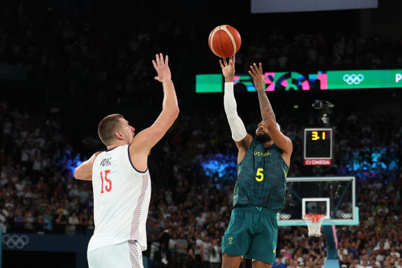 Patty Mills shoots over Nikola Jokic to level the quarter-final at full-time.