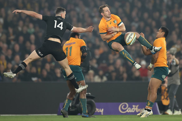 Bernard Foley of the Wallabies and Will Jordan of the All Blacks compete for the ball.