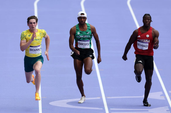Rohan Browning of Australia (left) competes during the men’s 100m heats on Saturday.