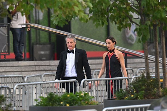 Hugh Grant and Anna Eberstein arrive at the reported wedding of Taylor Swift and Travis Kelce. 