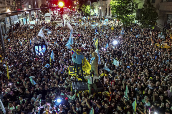 Supporters of presidential candidate Javier Milei celebrate outside his campaign headquarter his victory over Economy Minister Sergio Massa.