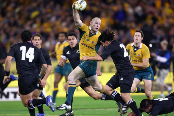 Stirling Mortlock offloads for a Wallabies try in 2007 at the MCG.