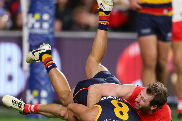 Josh Rachele of the Crows is tackled by Harry Cunningham.