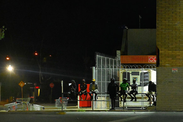 A group of people of mixed ages in the central business area of Alice Springs.