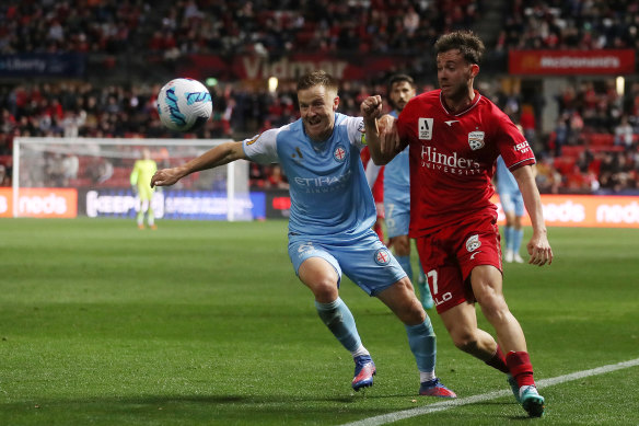 Scott Jamieson of Melbourne City and Adelaide’s Lachlan Brook vie for possession.