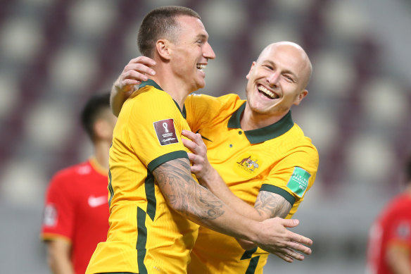 Mitch Duke and Aaron Mooy celebrate the former’s 70th-minute strike against China.