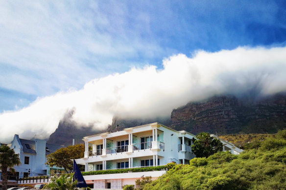 Camps Bay 12 Apostles Hotel under mist-covered peaks.