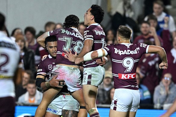 The Sea Eagles celebrate a try.