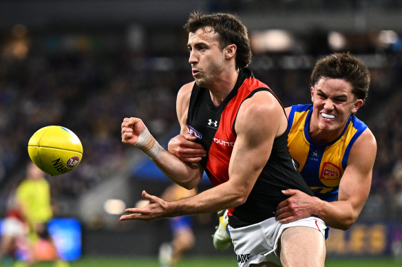 Andrew McGrath of the Bombers is tackled by Noah Long of the Eagles.