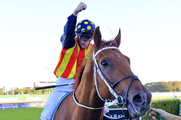 James McDonald punches the air after returning a winner on Nature Strip in the TJ Smith