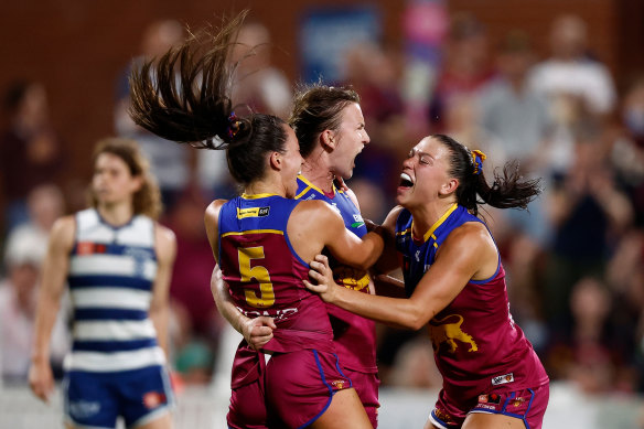 Jade Ellenger, Shannon Campbell and Poppy Boltz of the Lions celebrate during the win over the Cats.