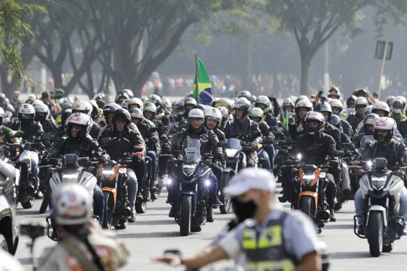 Bolsonaro (centre), leads motorcycle enthusiasts who gathered in a show of support for the President. 