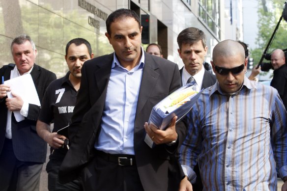 Rob Karam, centre, leaves the Melbourne Magistrates Court  in March 2009.