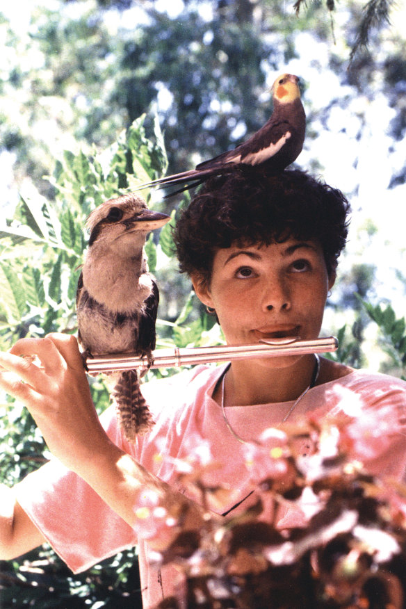 Playing the flute with an avian entourage.