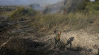 A police officer inspects the area around a fire after the military said it fired interceptors at a missile launched from Yemen that landed in central Israel. 