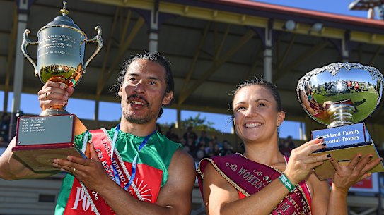 Edward Ware (left) and Hayley Orman hold their trophies after winning their races during the 139th running of the Stawell Gift at Central Park.