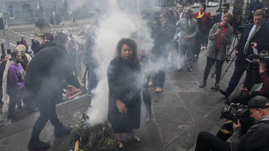 Victorian MPs attending a smoking ceremony on the steps of Parliament House ahead of the debate on the Treaty Authority Bill.