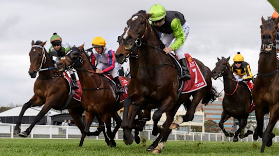 Brett Prebble riding Incentivise (L) in to the first turn before winning the Caulfield Cup